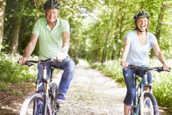Senior Couple On Cycle Ride In Countryside