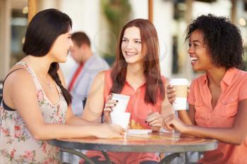 Three Female Friends Meeting In Caf
