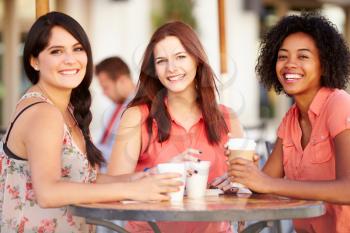 Three Female Friends Meeting In Caf