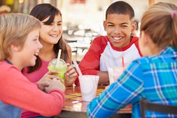 Group Of Children Hanging Out Together In Caf