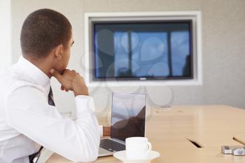 Businessman Having Video Conference In Boardroom