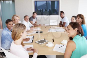 Group Of Businesspeople Meeting In Boardroom