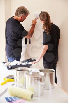 Decorators painting the walls of a house