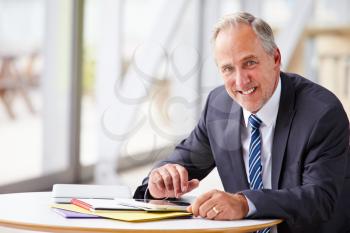 Portrait of smiling senior corporate businessman, waist up