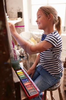 Young Girl Working On Painting In Studio