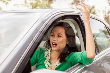 Frustrated female Asian driver in a car
