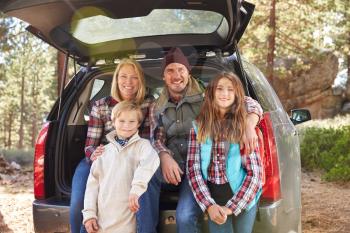Portrait of family by their car before hiking, California