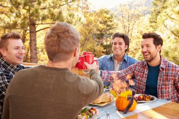 Group Of Gay Male Friends Enjoying Outdoor Meal Together