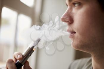 Close Up Of Man Using Vapourizer As Smoking Alternative