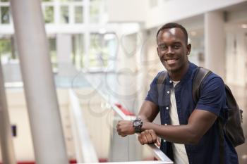 Smiling black male student in modern university, portrait