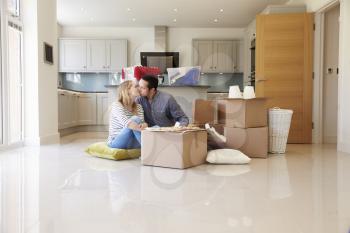 Couple Celebrating Moving Into New Home With Pizza