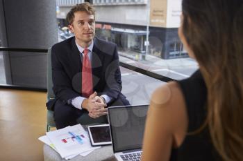 Young businessman and woman at an informal meeting in office