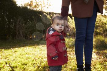 Young Girl On Autumn Walk With Mother