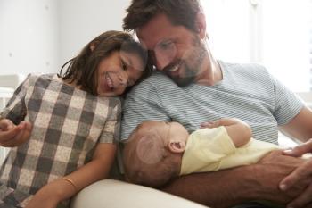 Father With Daughter And Newborn Son In Nursery