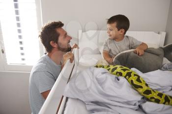 Father Saying Goodnight To Son At Bedtime