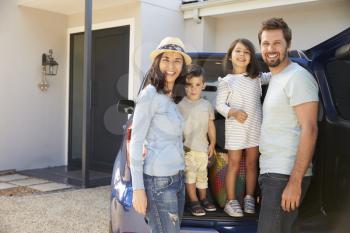 Portrait Of Family Packing Car Ready For Summer Vacation