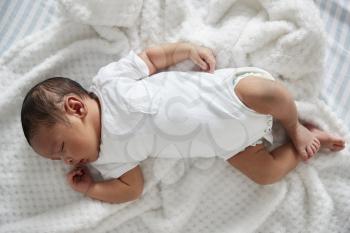 Newborn Baby Sleeping In Nursery Cot