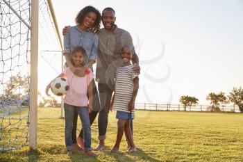 Portrait of a young black family during a football game