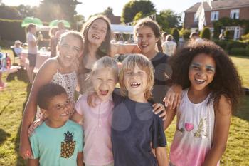 Portrait Of Excited Children At Summer Garden Fete