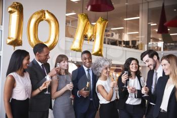 Business people celebrate meeting target in the office