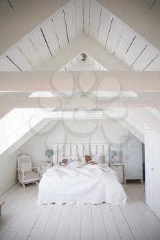 Couple Sleeping In Light And Airy White Bedroom