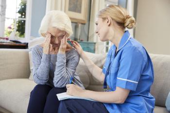 Community Nurse Visits Senior Woman Suffering With Depression