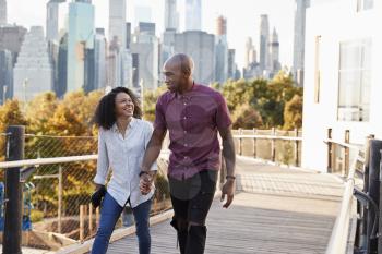 Couple Visiting New York With Manhattan Skyline In Background