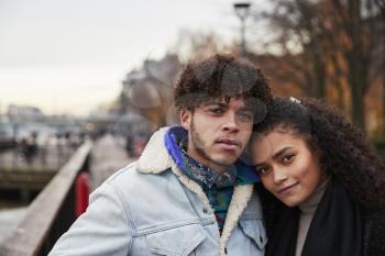 Portrait Of Couple Walking Along South Bank On Visit To London