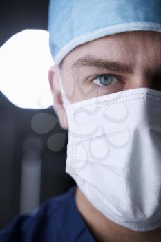 Male healthcare worker in scrubs head shot, vertical cropped
