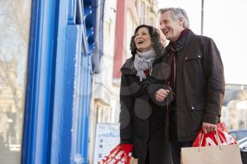Mature Couple Enjoying Shopping In City Together