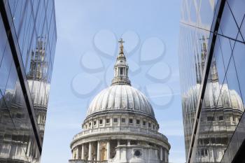 LONDON - MAY, 2017: The dome of St Pauls Cathedral seen between modern buildings, London, EC4.