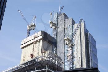 LONDON - MAY, 2017: Cranes working on construction of modern tower blocks in the City Of London, London