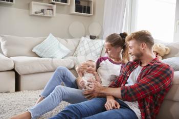 Young white family with toddler together in sitting room