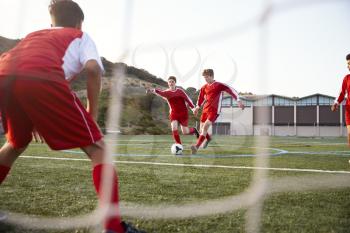 Group Of Male High School Students Playing In Soccer Team