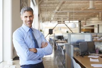 Smiling white male architect in office looking to camera