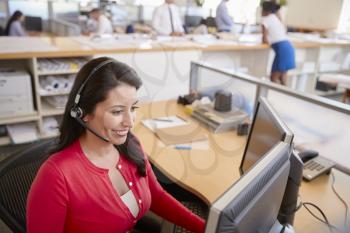Hispanic woman working in a call centre, elevated view