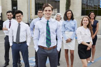 Young white businessman and colleagues outdoors, portrait