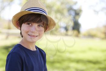 Young schoolboy in a sun hat smiling, close up portrait
