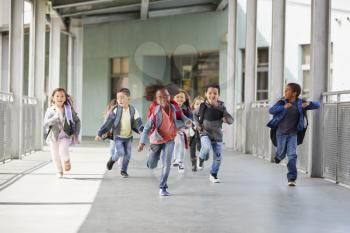 Elementary school kids running in a corridor in the school