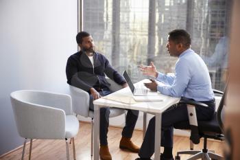 Man Meeting With Male Financial Advisor Relationship Counsellor In Office
