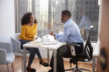 Woman Meeting With Male Financial Advisor Relationship Counsellor In Office