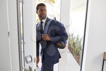 Businessman Wearing Suit Opening Door Leaving Home For Work
