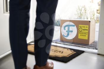 Close Up Of Man Opening Front Door To Fresh Food Home Delivery In Cardboard Box Outside Front Door