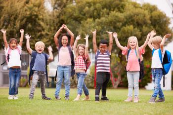 Excited Elementary School Pupils On Playing Field At Break Time