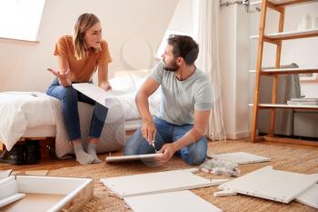 Couple Having Argument Whilst Putting Together Self Assembly Furniture