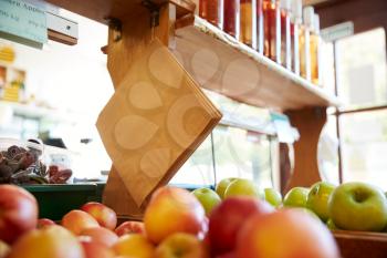 Paper Bags Hanging Over Fruit And Produce Displayed In Organic Farm Shop