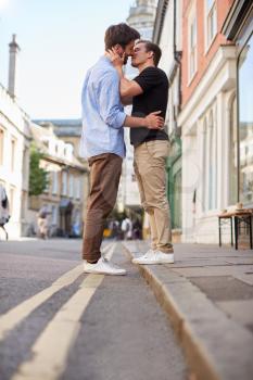 Loving Male Gay Couple Kissing Outside In City Street