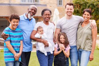 Portrait Of Smiling Multi-Generation Mixed Race Family In Garden At Home