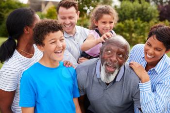 Smiling Multi-Generation Mixed Race Family Having Fun In Garden At Home