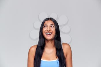 Studio Portrait Of Positive Happy Young Woman Laughing Off Camera